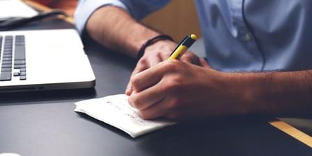 Man looking at his budget and bills to prevent overdraft