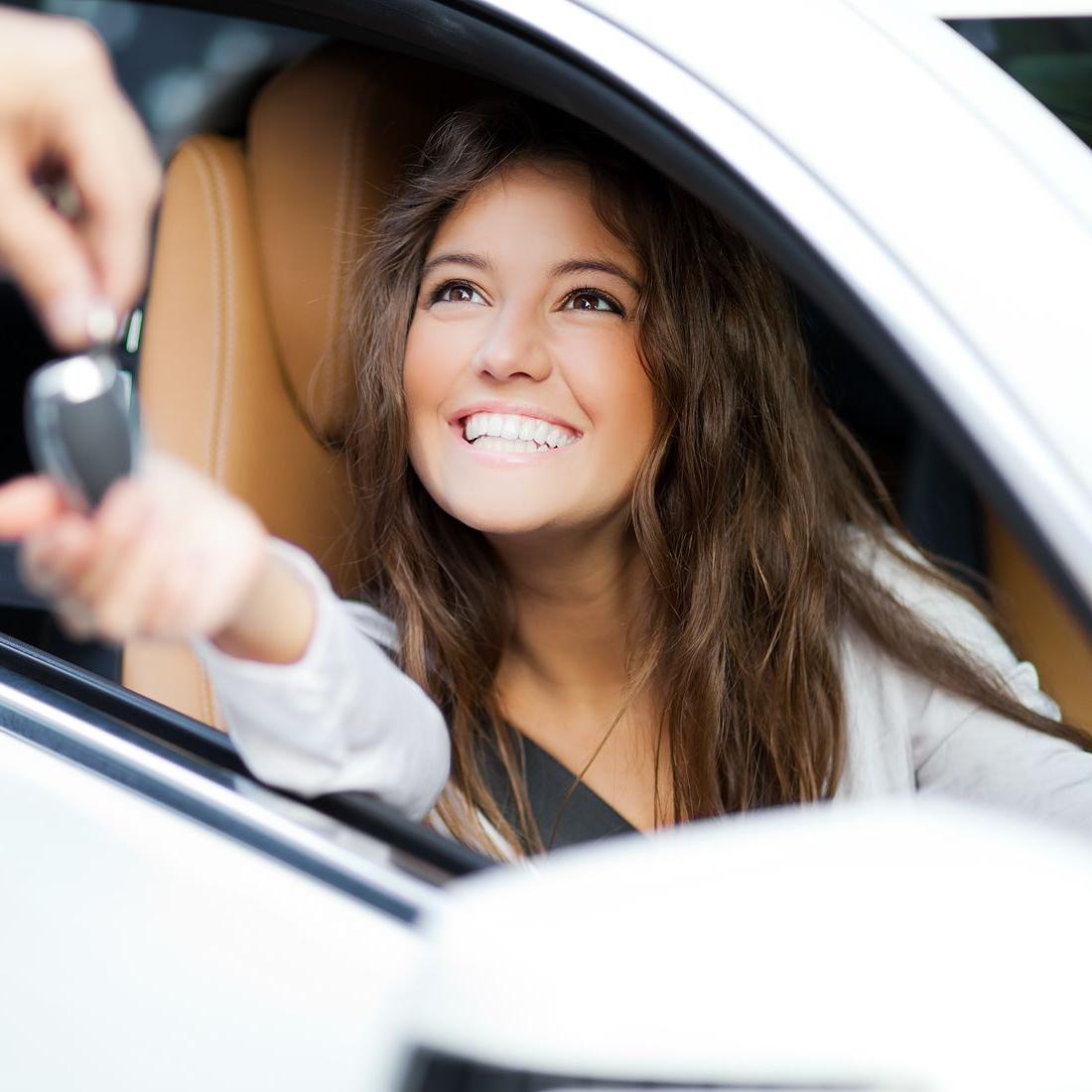 woman-receiving-keys-of-her-new-car-from-dealer-1100x1100